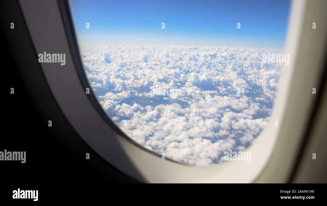 Fluffy cloudscape viewed from airplane window, beautiful nature, vacation trip Stock Photo