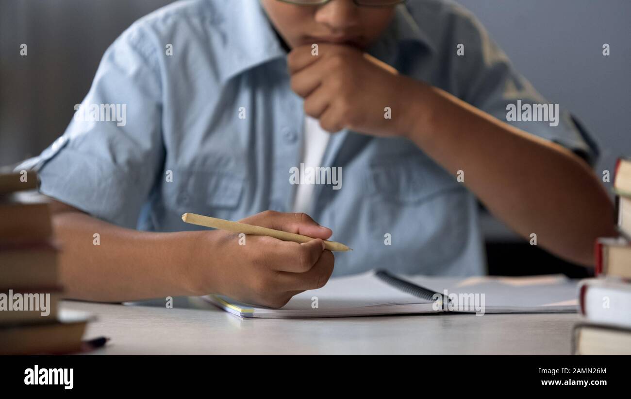 Clever school pupil thinking on solving equation, learning math, knowledge  Stock Photo - Alamy