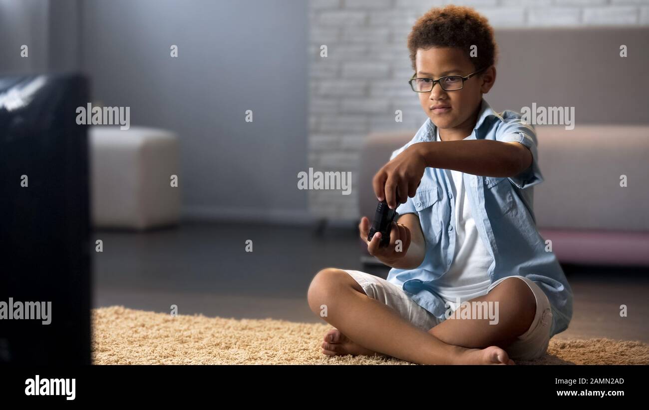 Boy playing video game on floor hi-res stock photography and images - Alamy