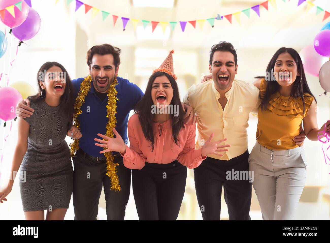 Group of colleagues having fun at a party in office. Stock Photo