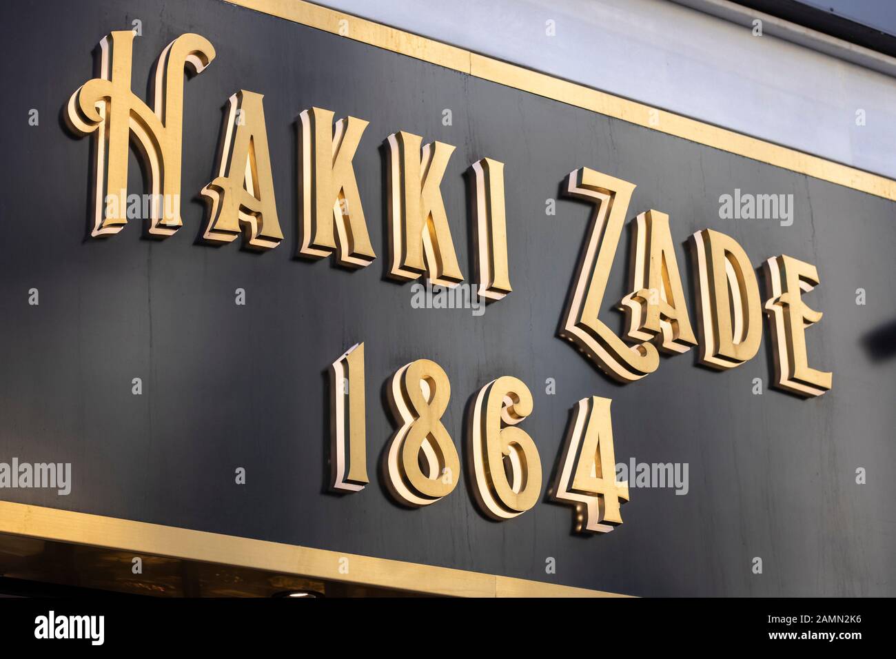 Hakki Zade was established in 1864 as a confectioner. Hakki Zade sign photographed nearby. Gold color on black surface. Stock Photo