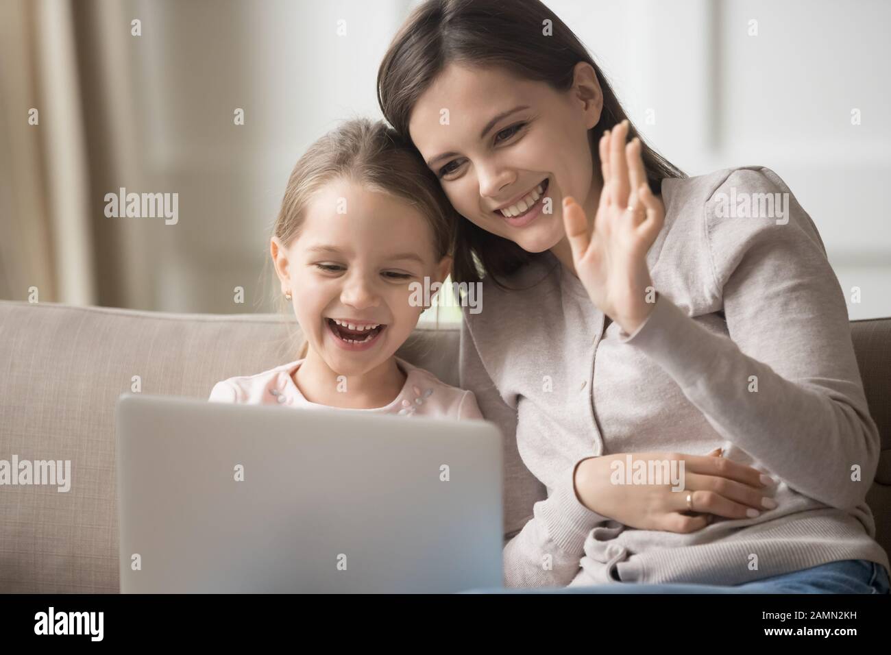 Happy mother and little daughter using laptop, making video call Stock ...