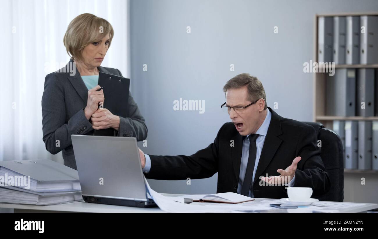 Angry boss yelling at new assistant, nervous breakdown, inappropriate behavior Stock Photo Alamy