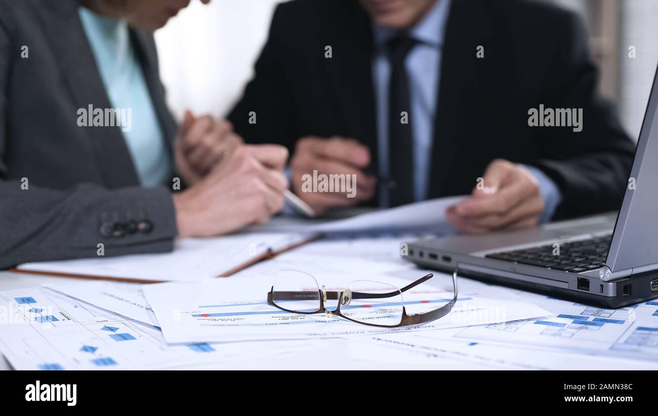 Bank representatives analyzing statistics reports financial charts, paper work Stock Photo
