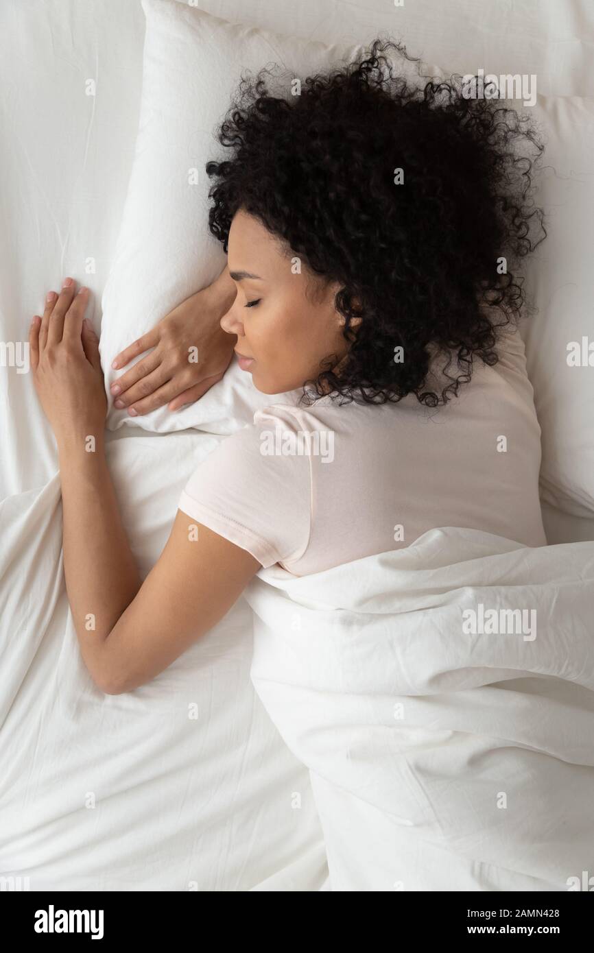 Above top vertical view african woman sleeping in bed Stock Photo