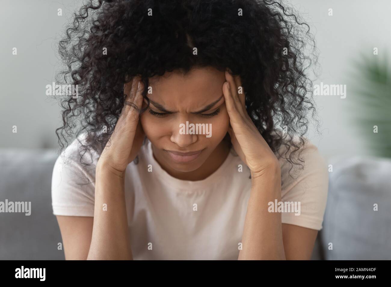 Close up unhealthy african woman touch temples feels headache Stock Photo