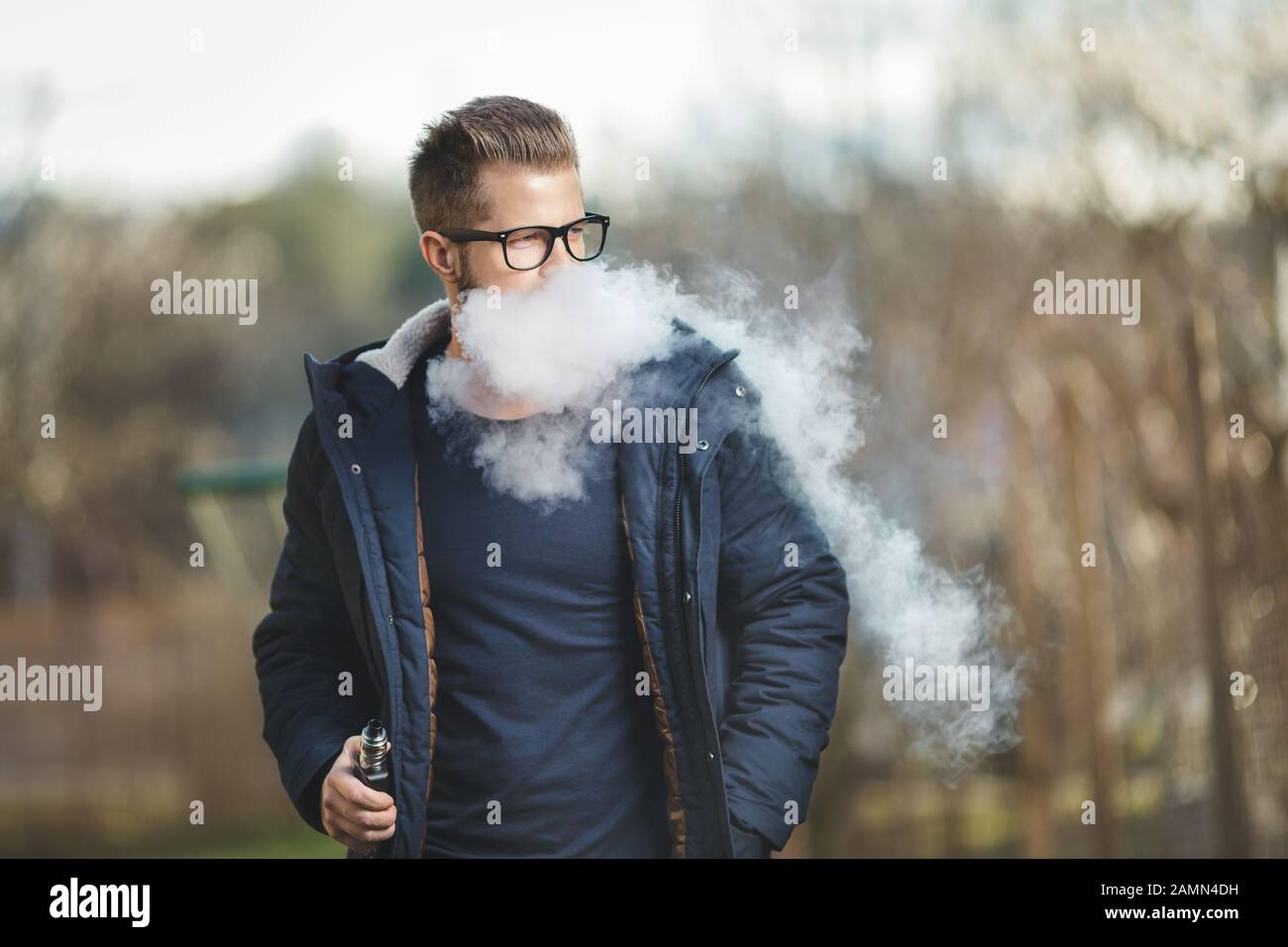 Vaping flavored e-liquid from an electronic cigarette Stock Photo