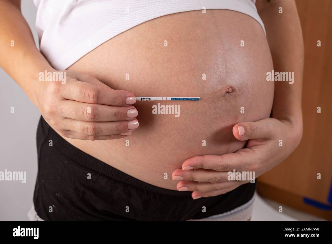 positive pregnancy test in woman hands close up Stock Photo