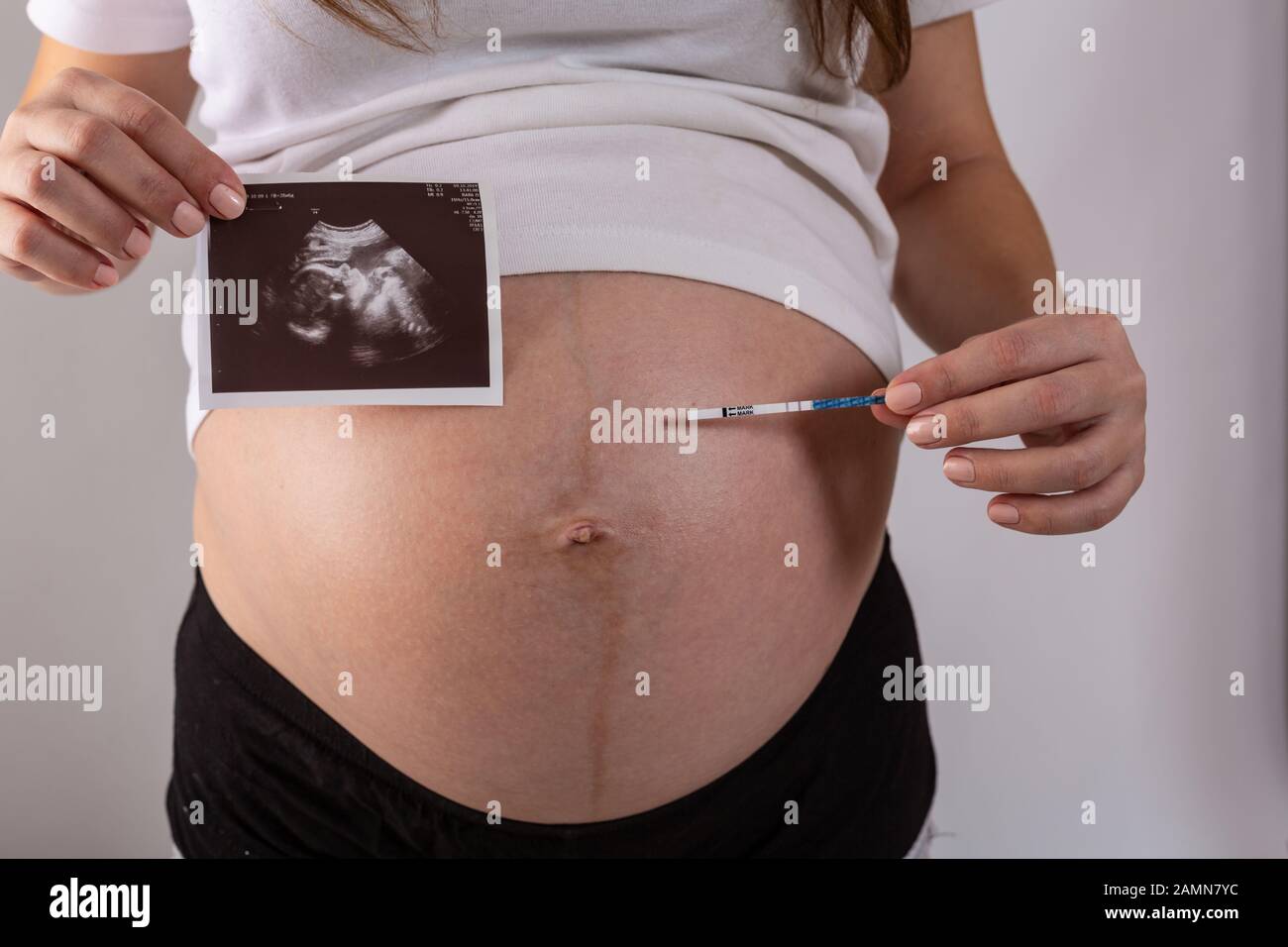 positive pregnancy test in woman hands close up Stock Photo