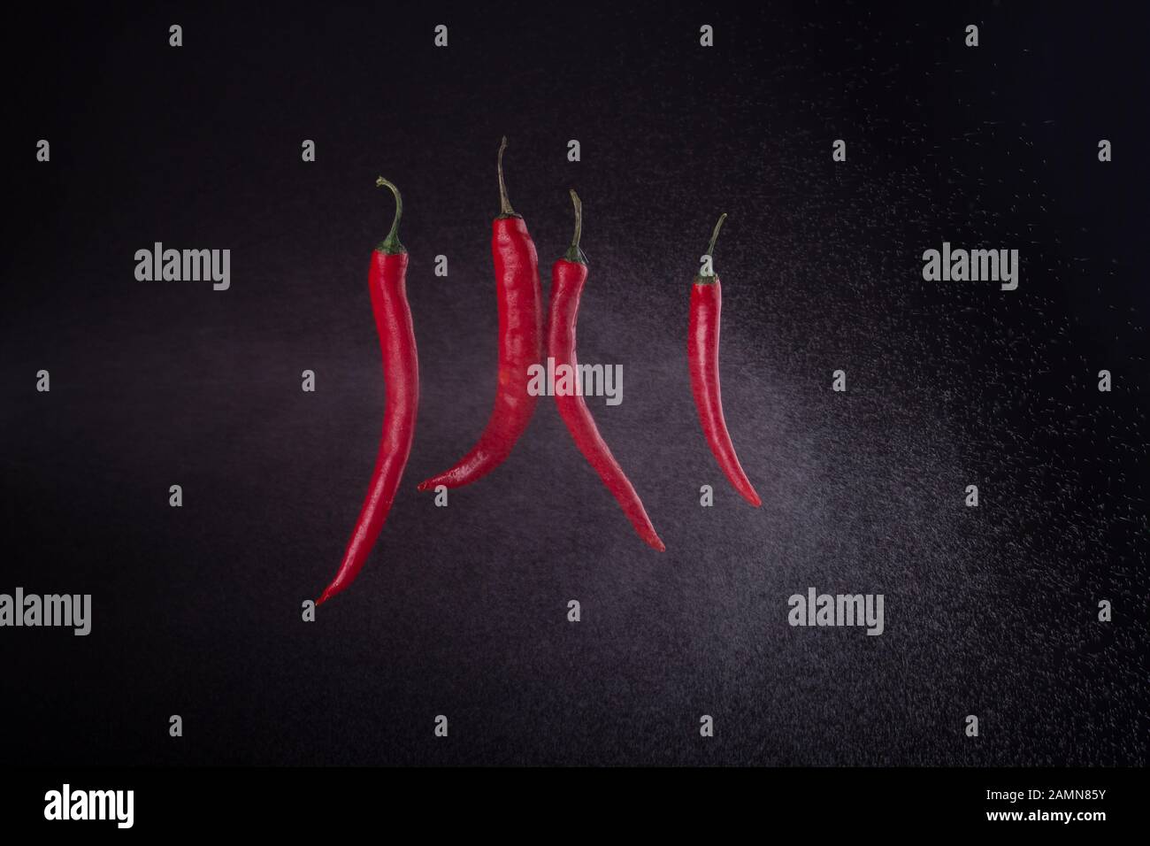 Four cayenne peppers sprayed with water Stock Photo Alamy