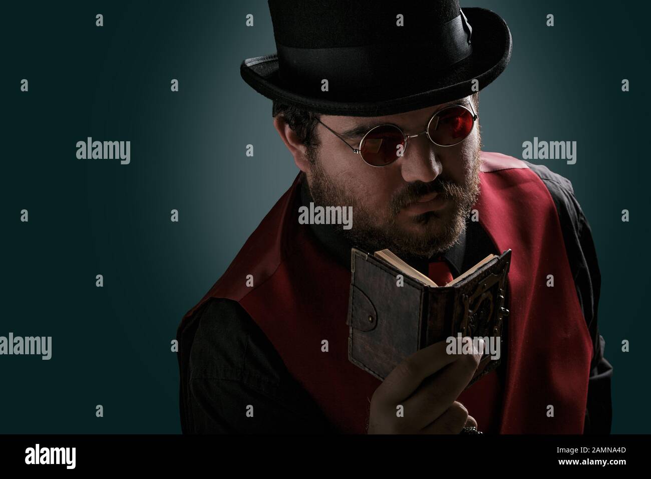 Portrait of a man steampunk reading book in top hat and round glasses