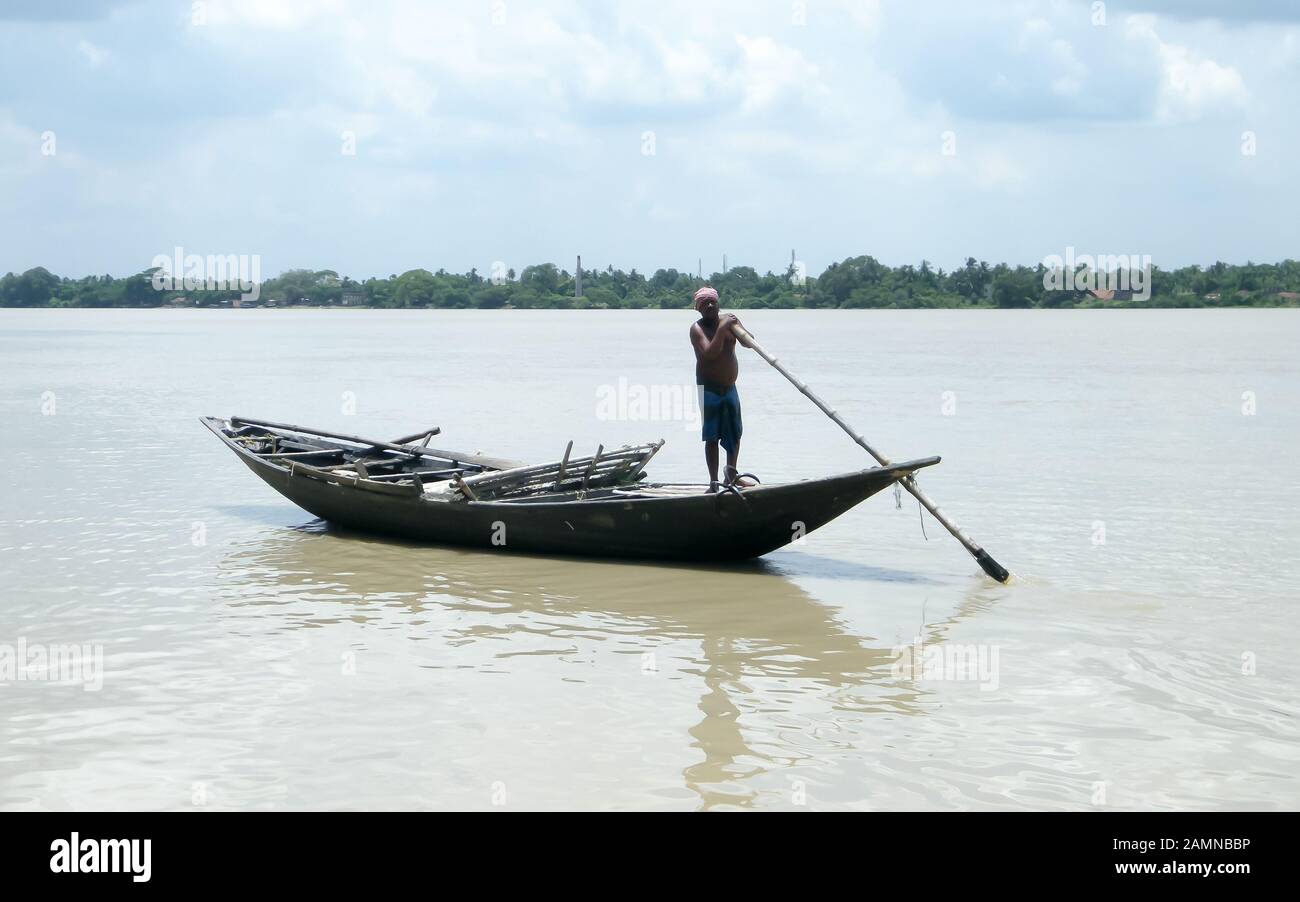 Traditional boatman (ferry people Majhi) rowing boat (called Nauka) on