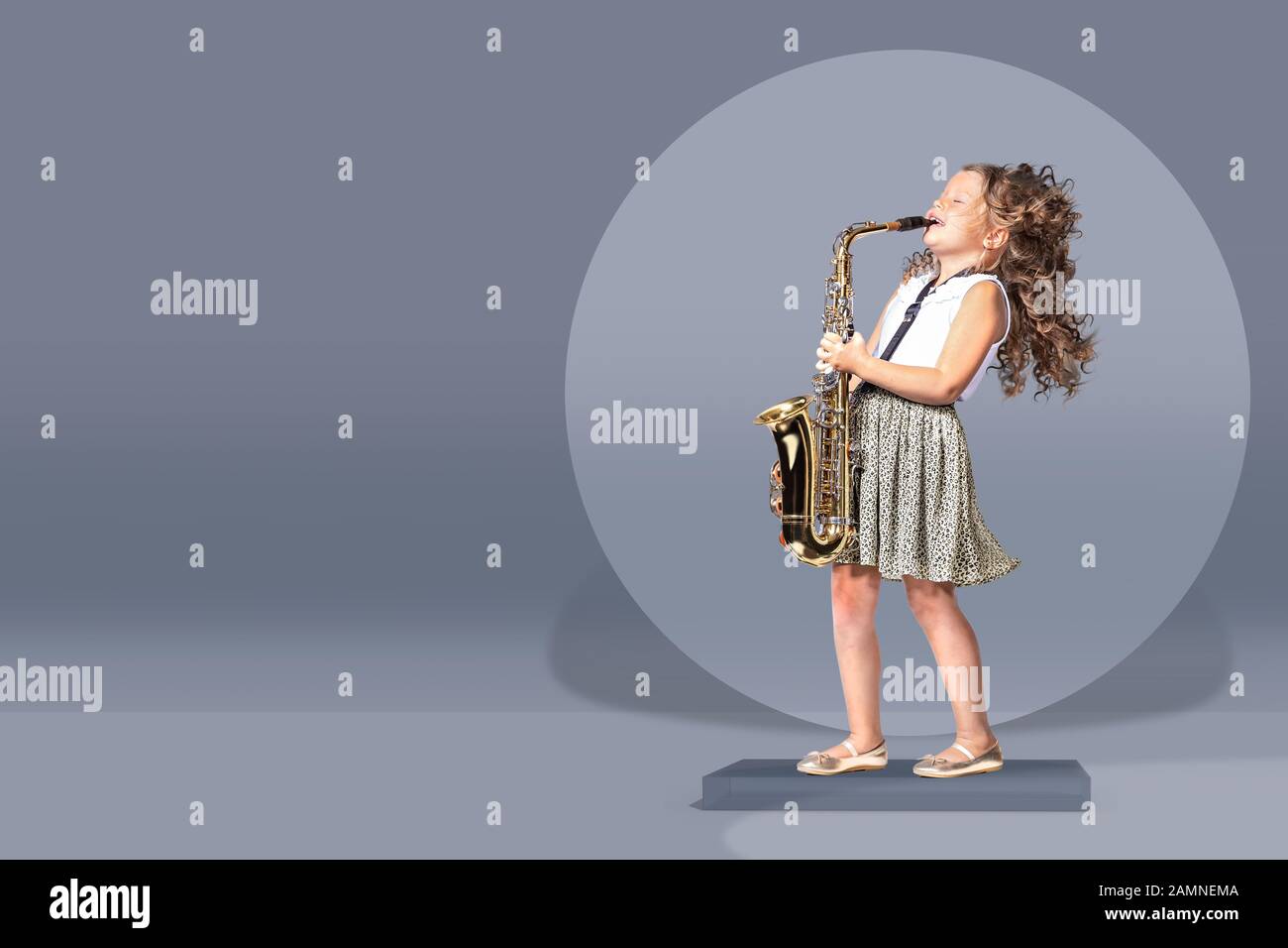 portrait of young girl with a saxophon on the stage Stock Photo