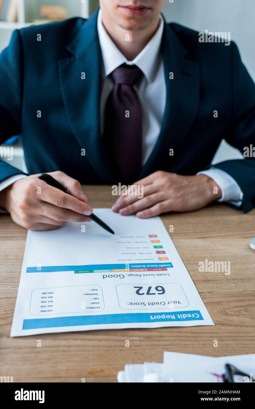cropped view of businessman in suit holding pen near document with letters Stock Photo