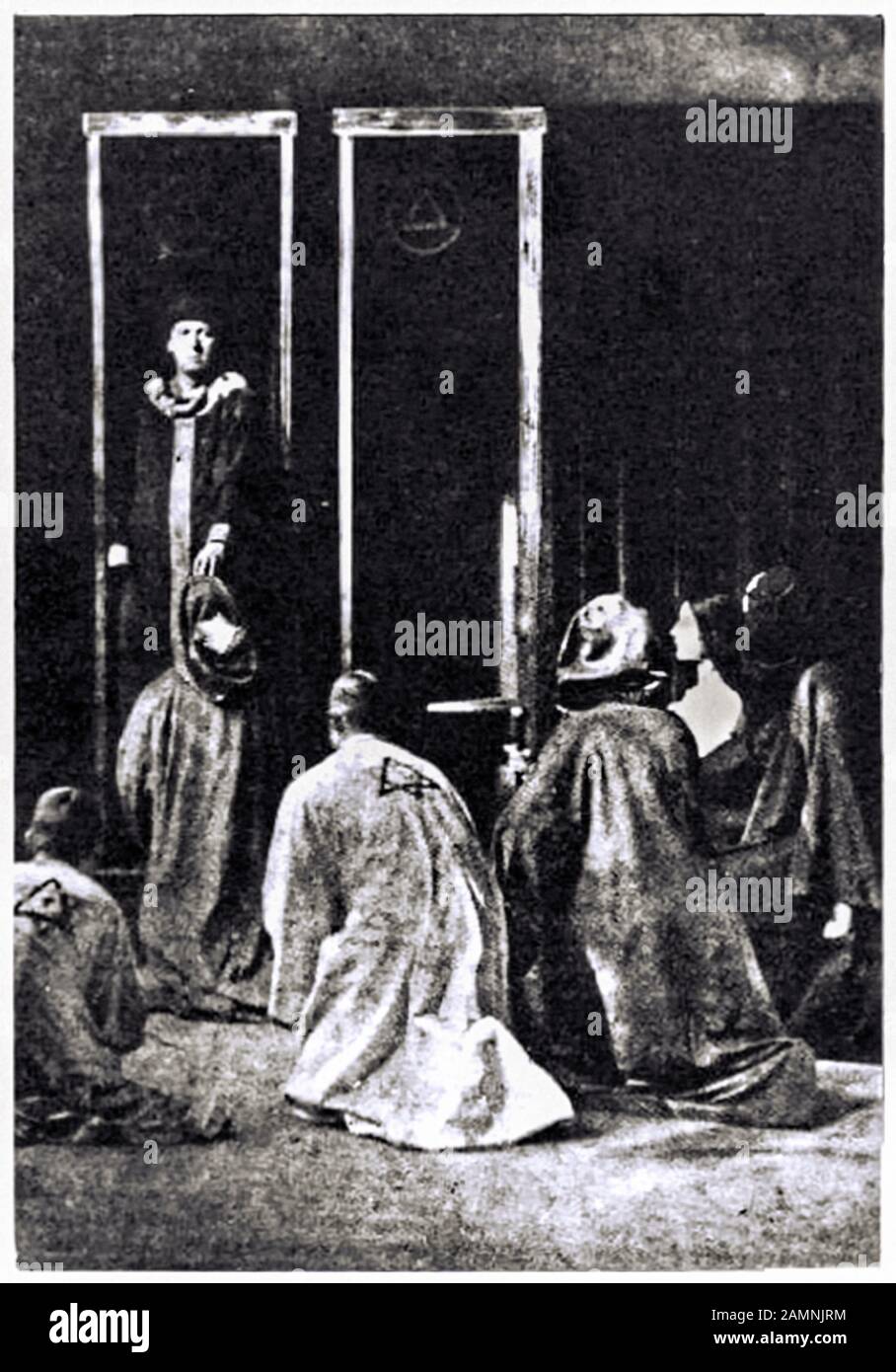 British occultist Aleister Crowley (1875-1947) performing the third act of the Rite of Saturn, part of the Rites of Eleusis, performed at Caxton Hall, London in October 1910 with Leila Waddell (1880-1932), Joan Hayes and Victor Benjamin Neuburg (1883-1940). Stock Photo