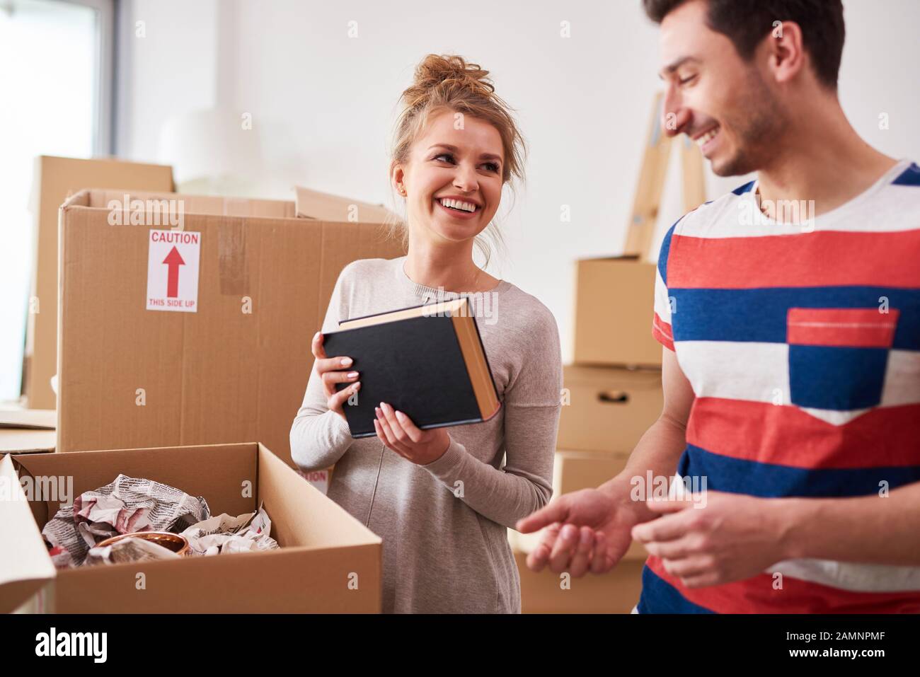 Couple packing books to the boxes Stock Photo Alamy