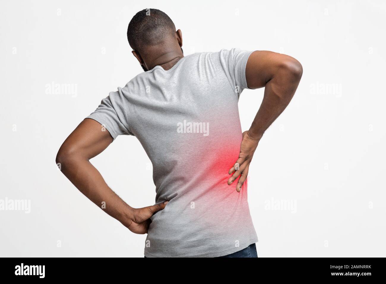 Black man holding his hand behind his back Stock Photo