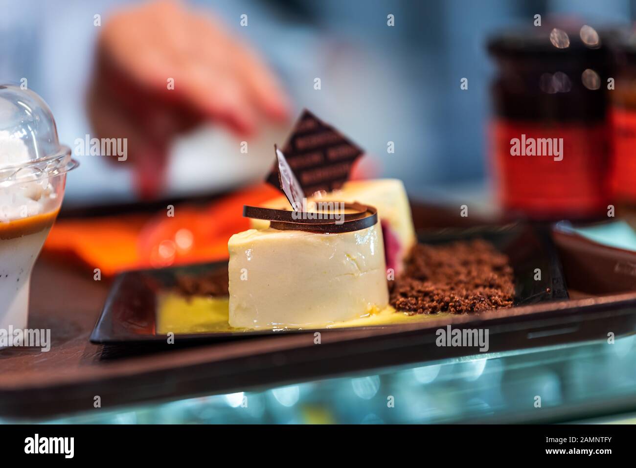 Closeup of chocolate dessert custard pastry on tray display in bakery