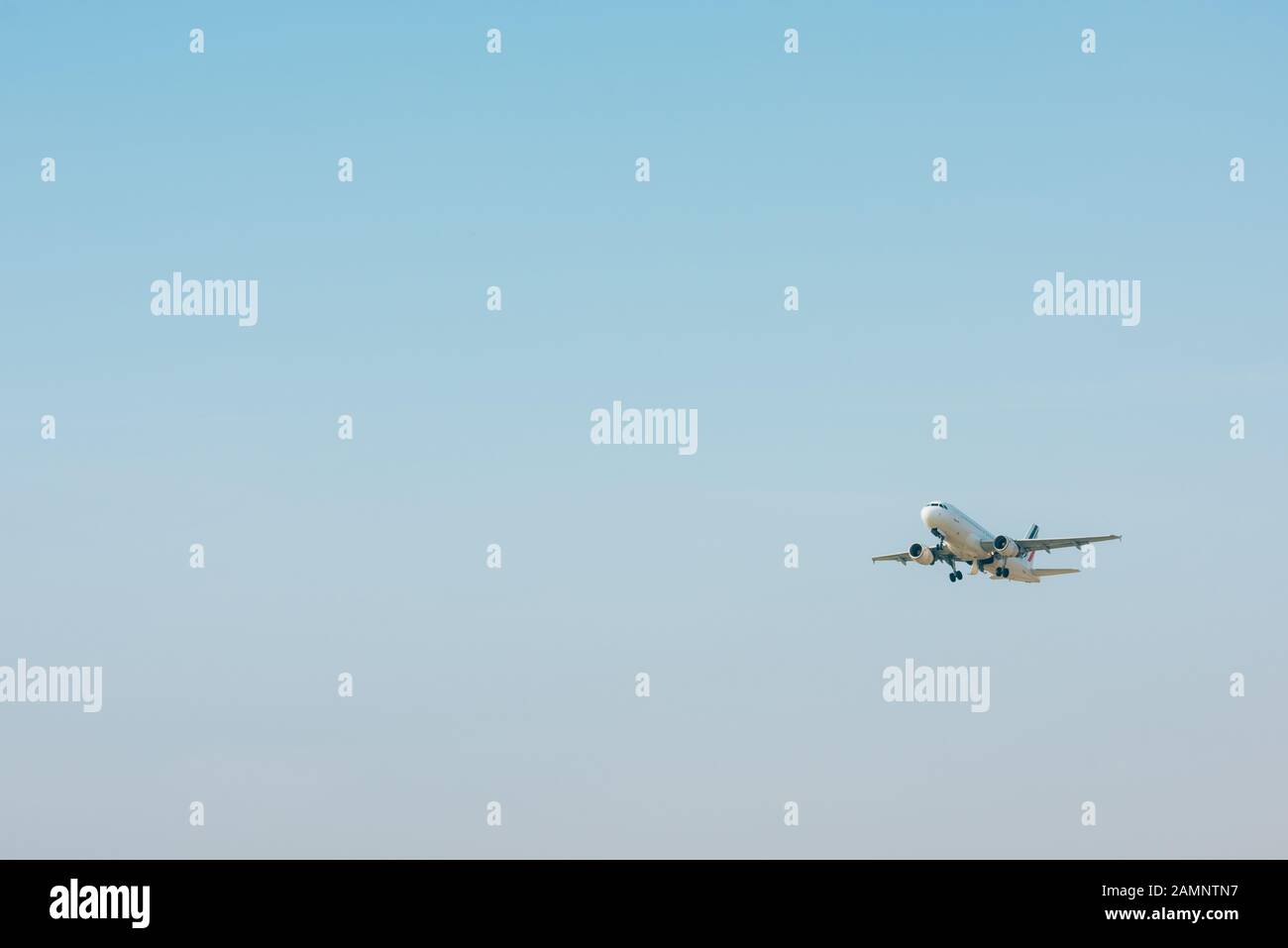 Airplane taking off in blue sky with copy space Stock Photo - Alamy