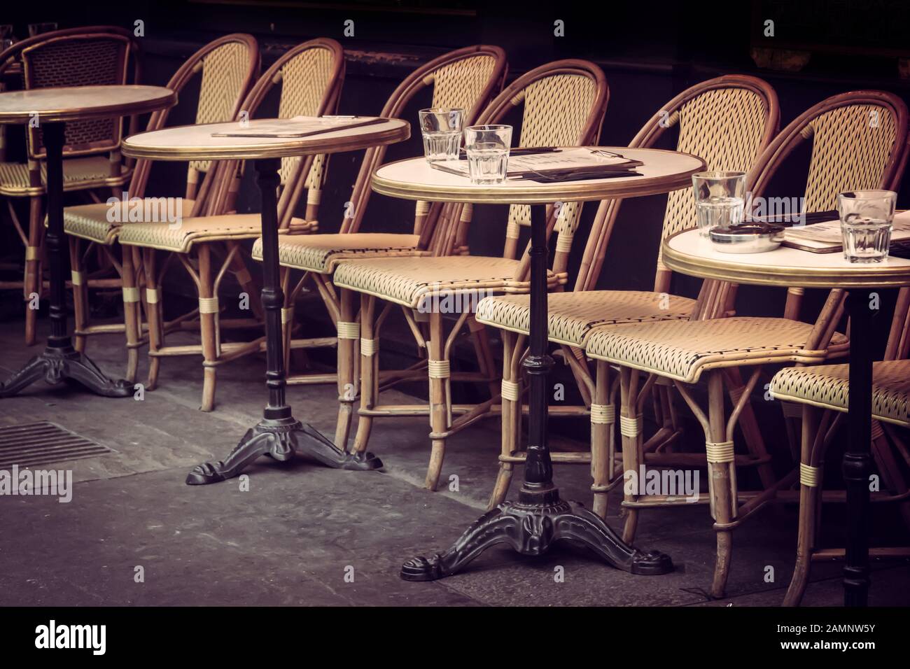 Empty retro tables and chairs on a outdoor cafe terrace in Paris, France Stock Photo
