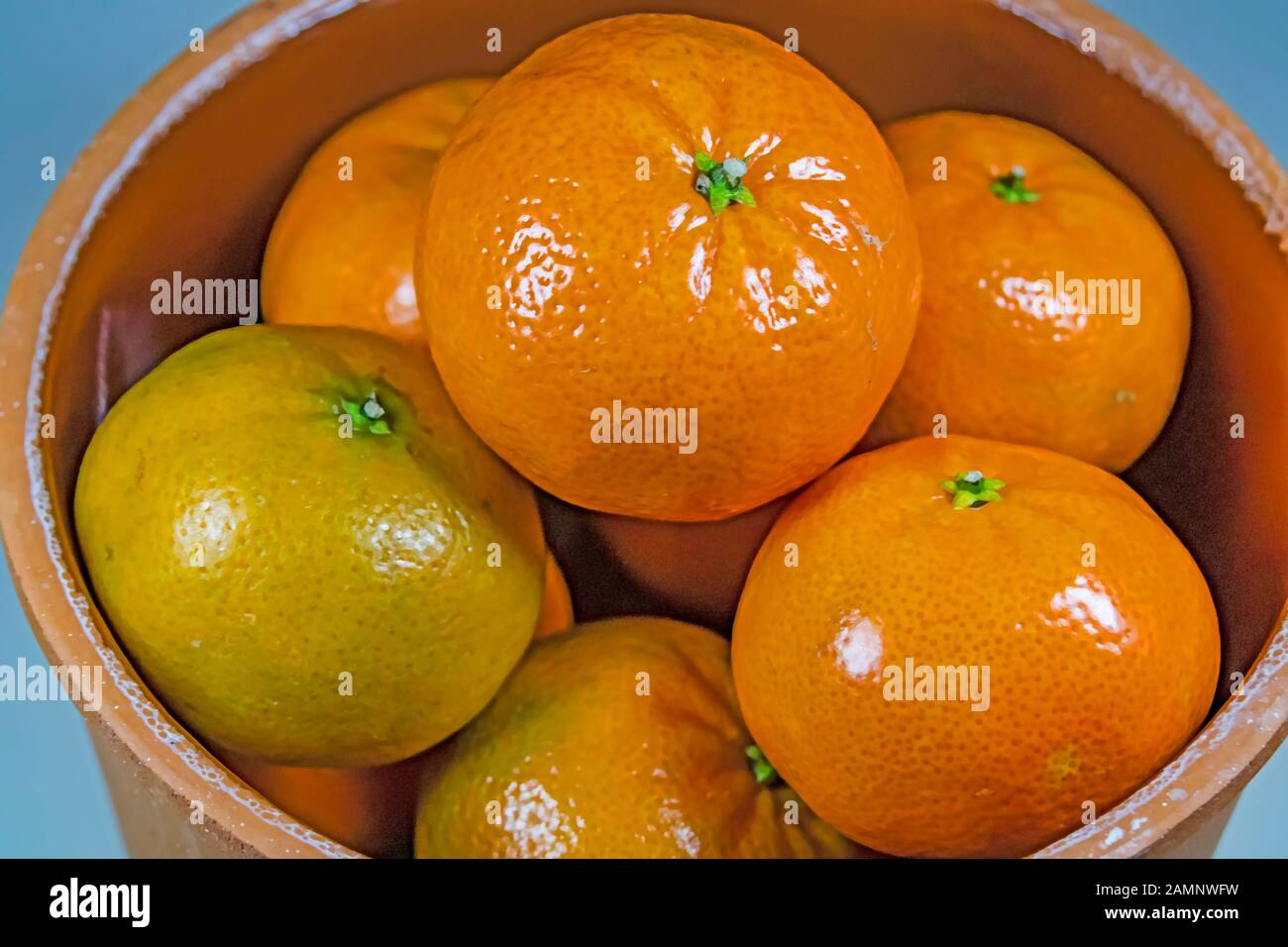 close up mandarin fruits in pottery bowl Stock Photo Alamy
