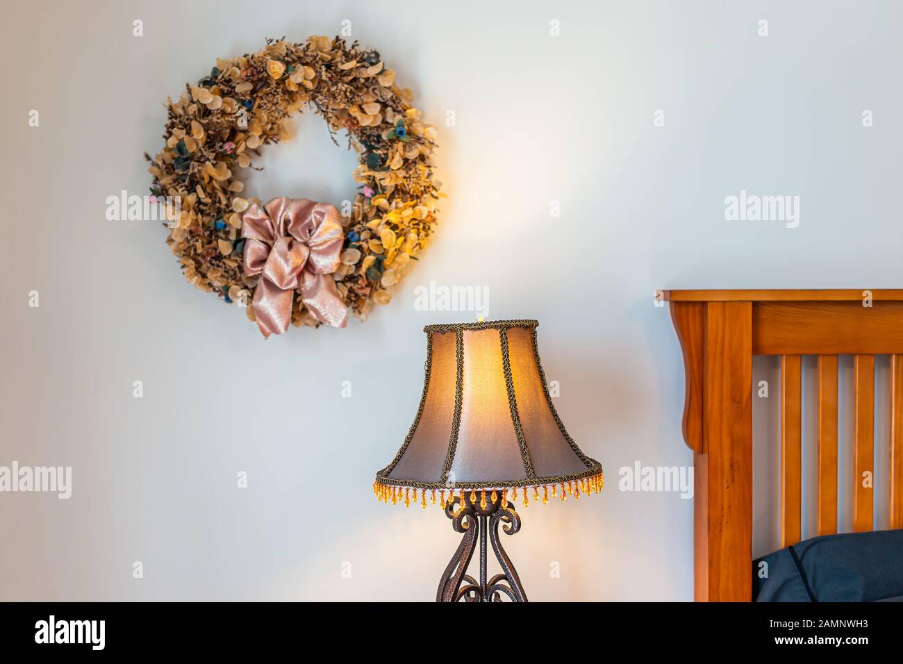 Retro Vintage Antique Room Wreath Dry Flower Decorations In Home House Hanging On Wall By Lamp And Bed In Bedroom Stock Photo Alamy
