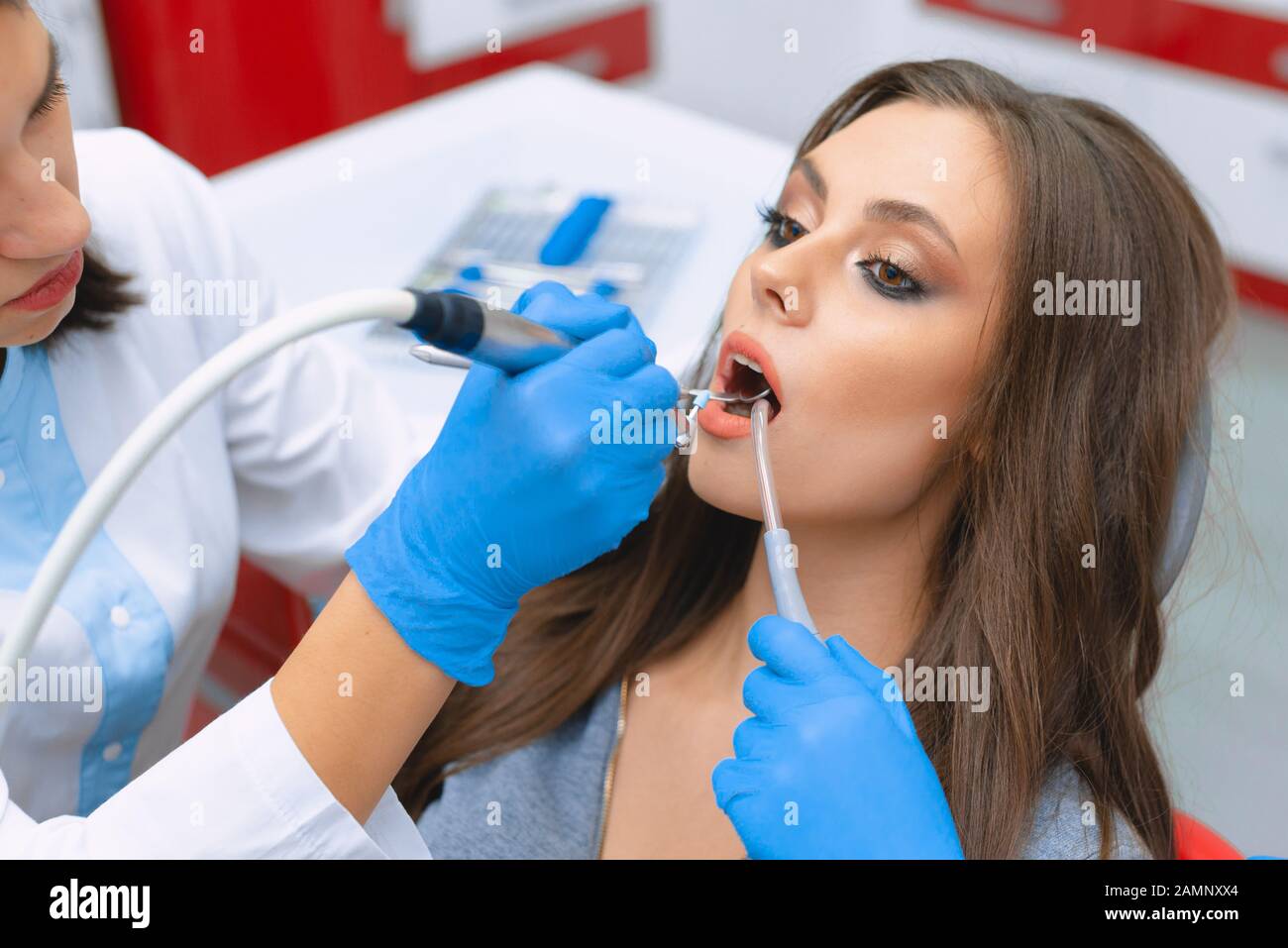 Cleaning and polishing tooth enamel in the dental office. Young girl in the dental office. Stock Photo