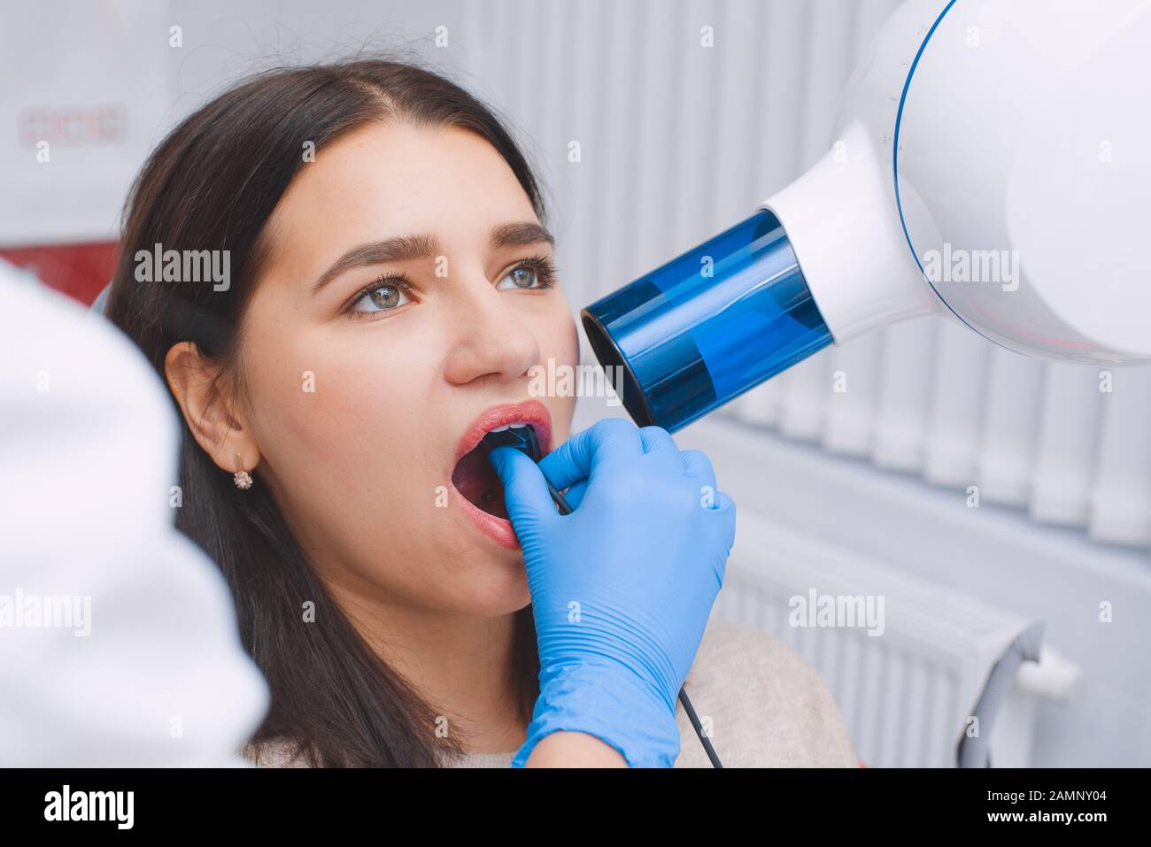 Tooth x-ray in the dental office. Young girl at the dentist's appointment. Stock Photo
