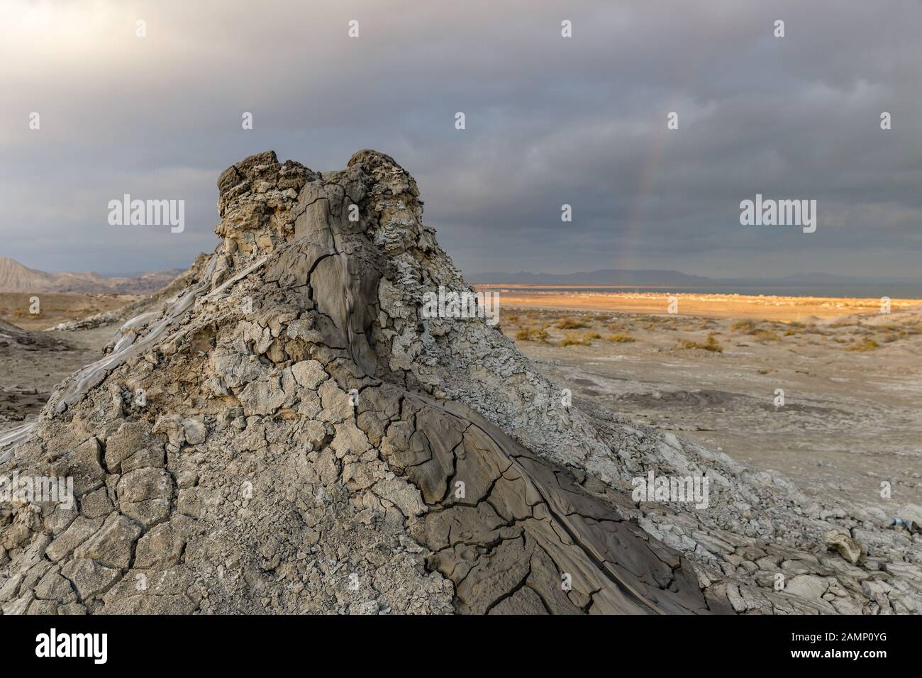 Mud volcanoes of Gobustan near Baku, Azerbaijan. Mud mountain against the backdrop of a stormy sky. Stock Photo