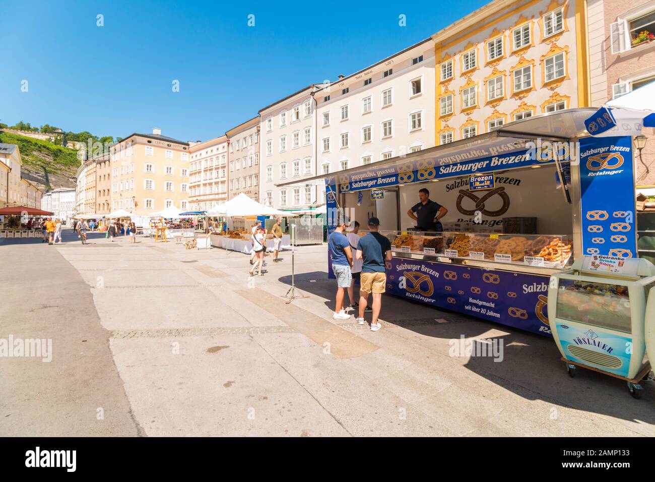 Salzburg, Austria - July 23, 2019: People looking at a market stall with different kinds of  pretzels (brezen) on the outdoor market . Stock Photo
