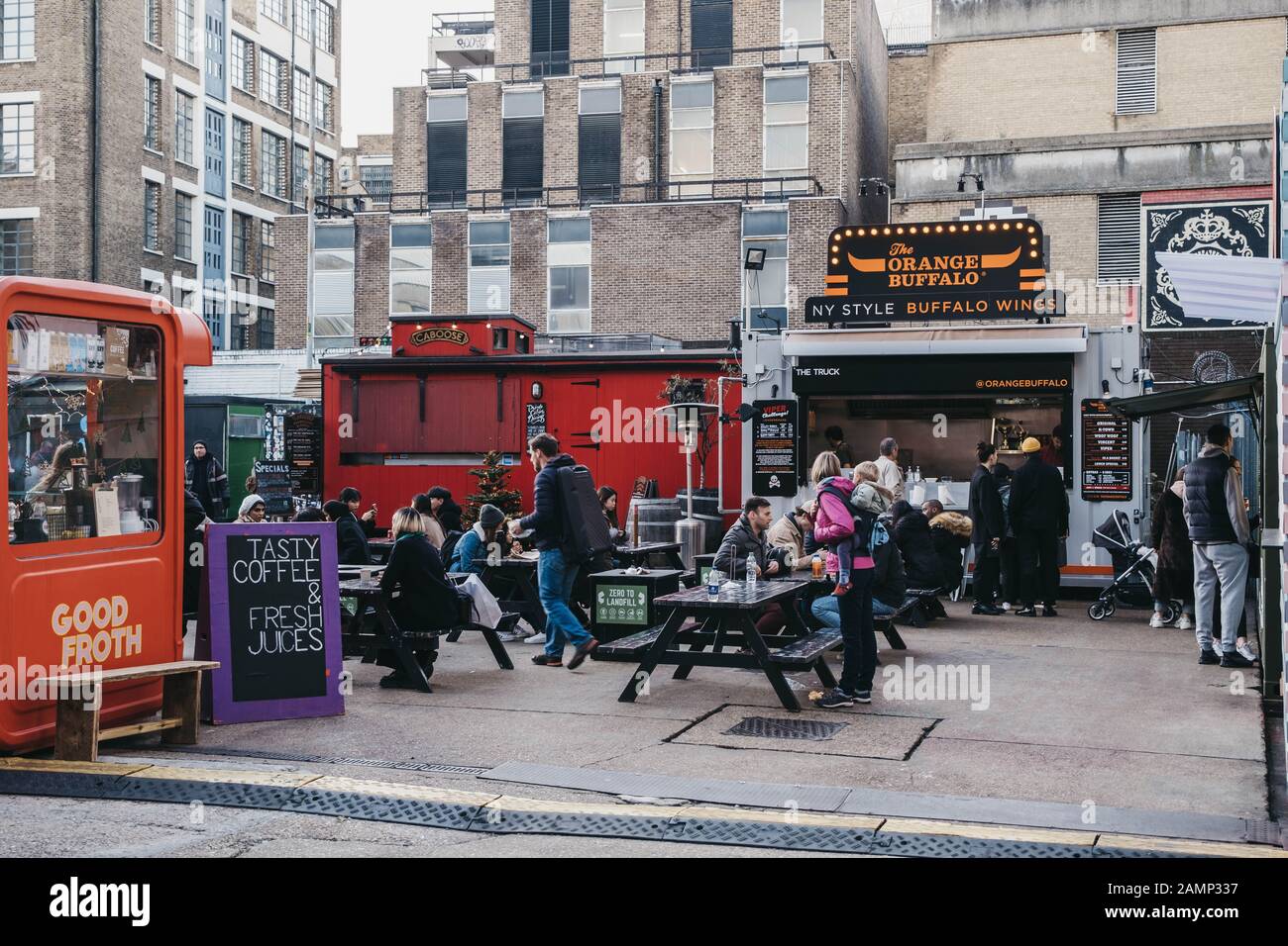 London, UK - December 29, 2019: People enjoying street food in Elys Yard, a popular industrial-style street food market just off Brick Lane, East Lond Stock Photo