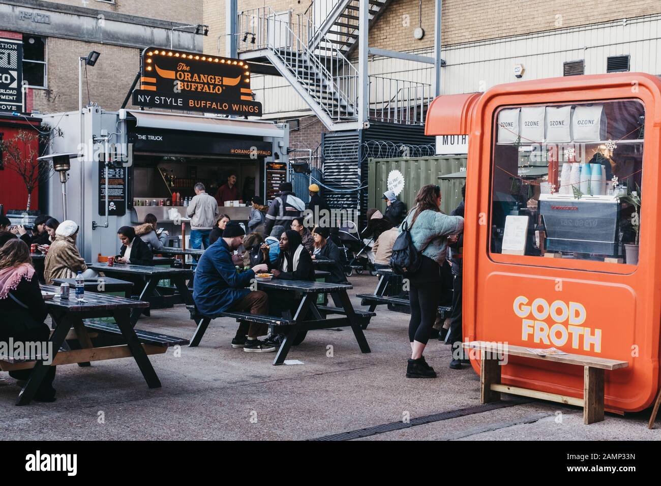 London, UK - December 29, 2019: People enjoying street food in Elys Yard, a popular industrial-style street food market just off Brick Lane, East Lond Stock Photo