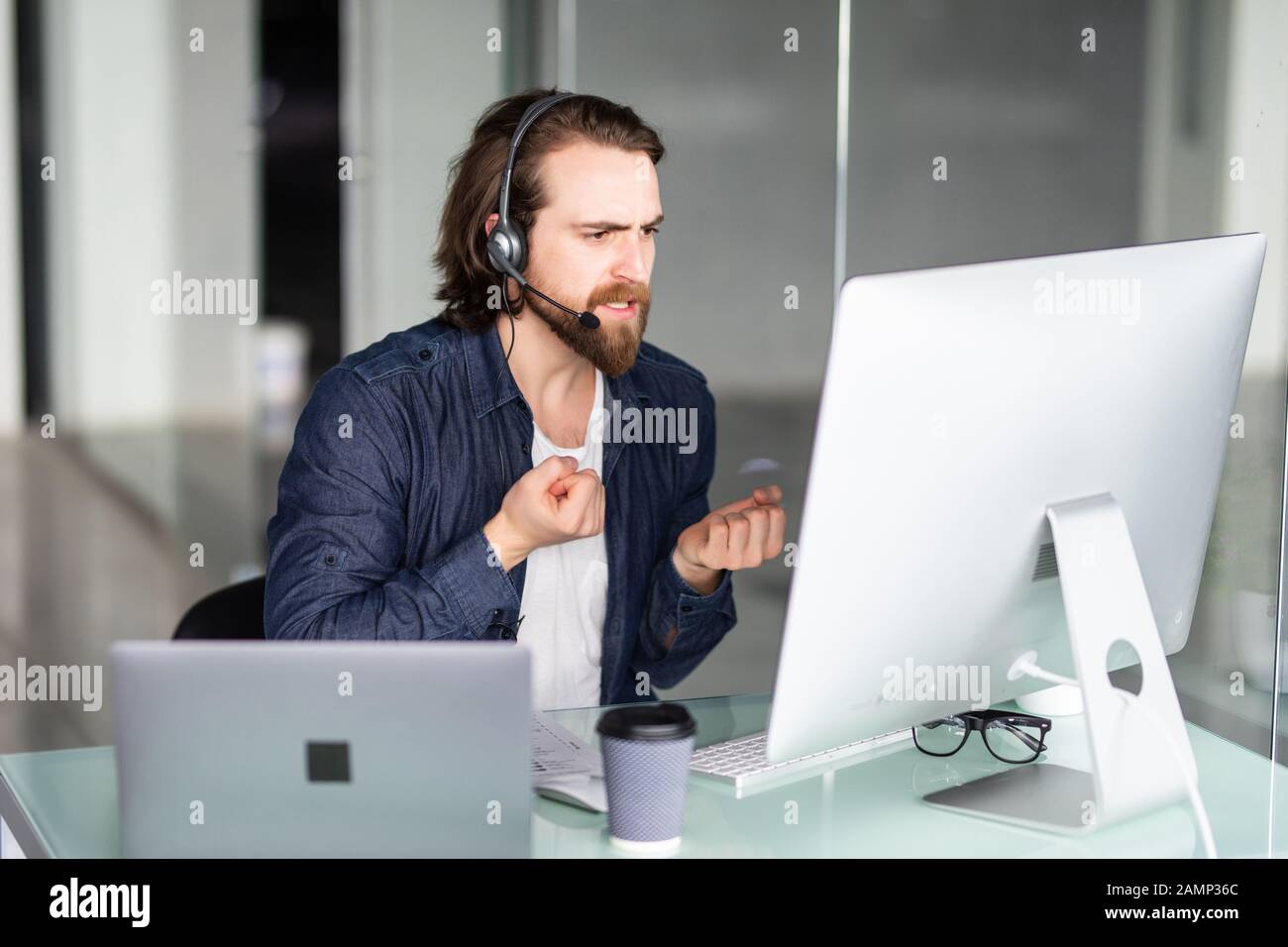 Call center operator working at his desk Stock Photo - Alamy