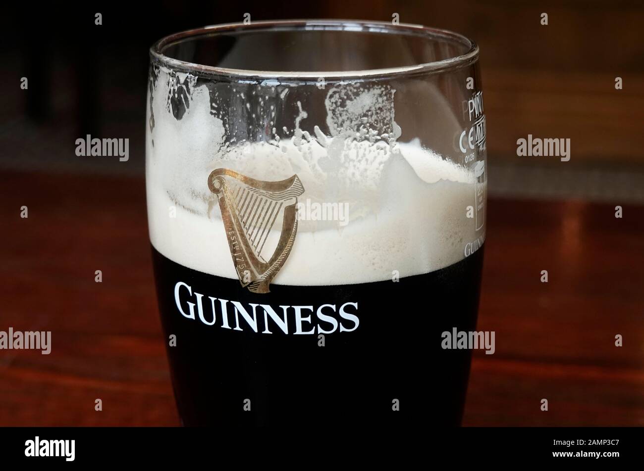A pint of Guinness in a tall thin glass Stock Photo