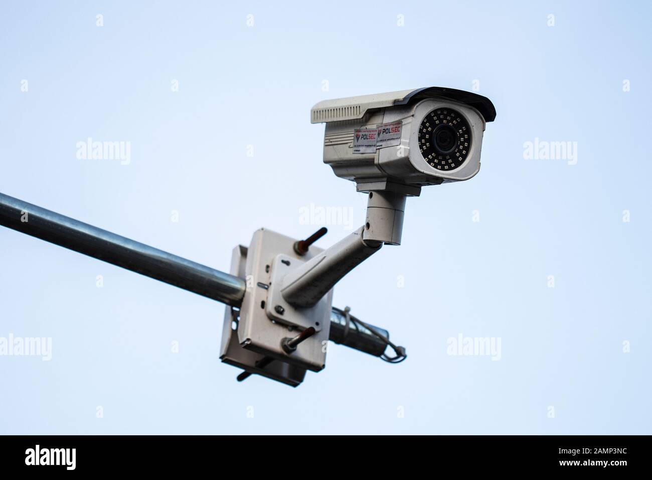 Security camera mounted on boom arm outside of bulding Stock Photo