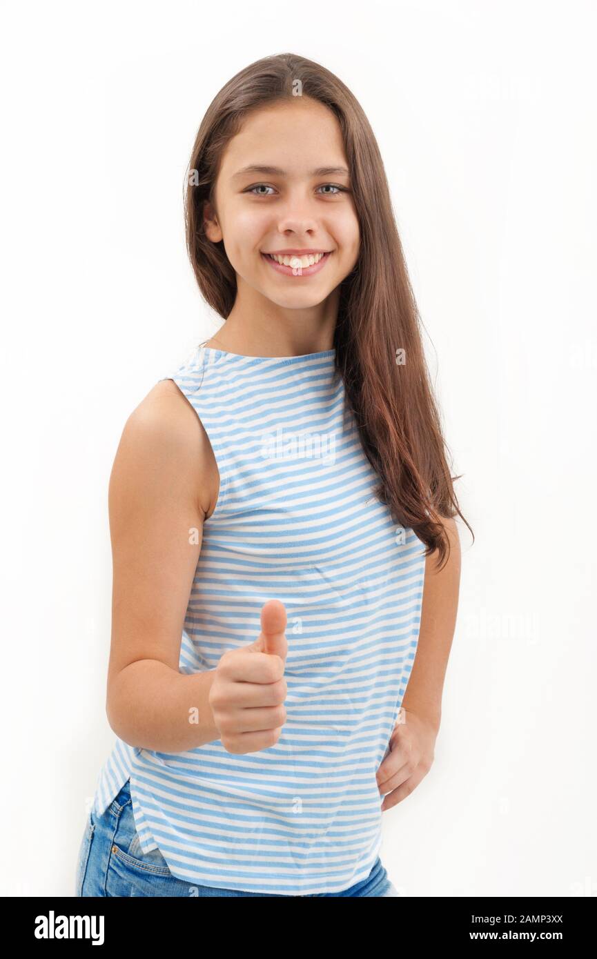 Girl showing thumbs up on a white background Stock Photo - Alamy