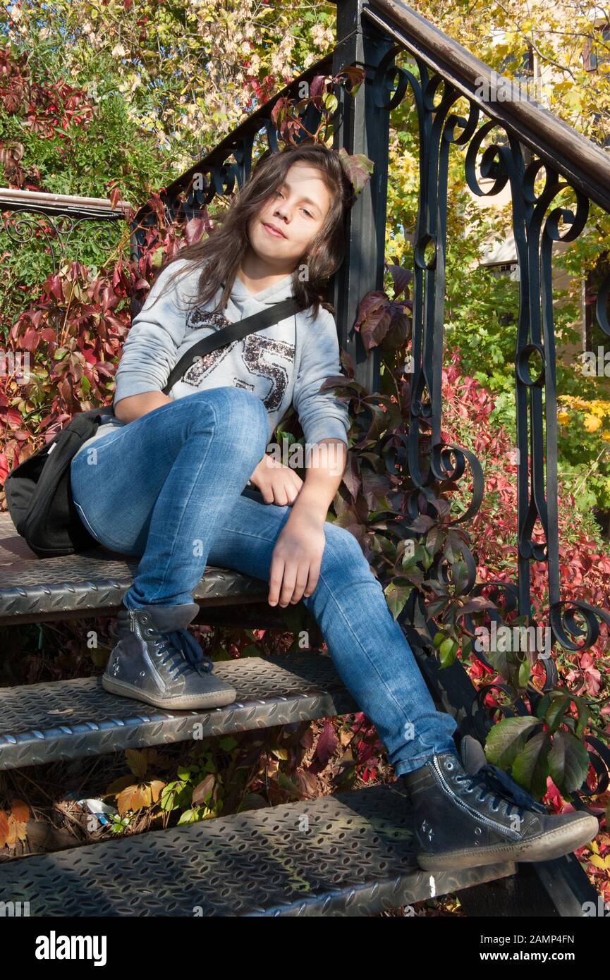 Beautiful teen girl sitting on the steps Stock Photo