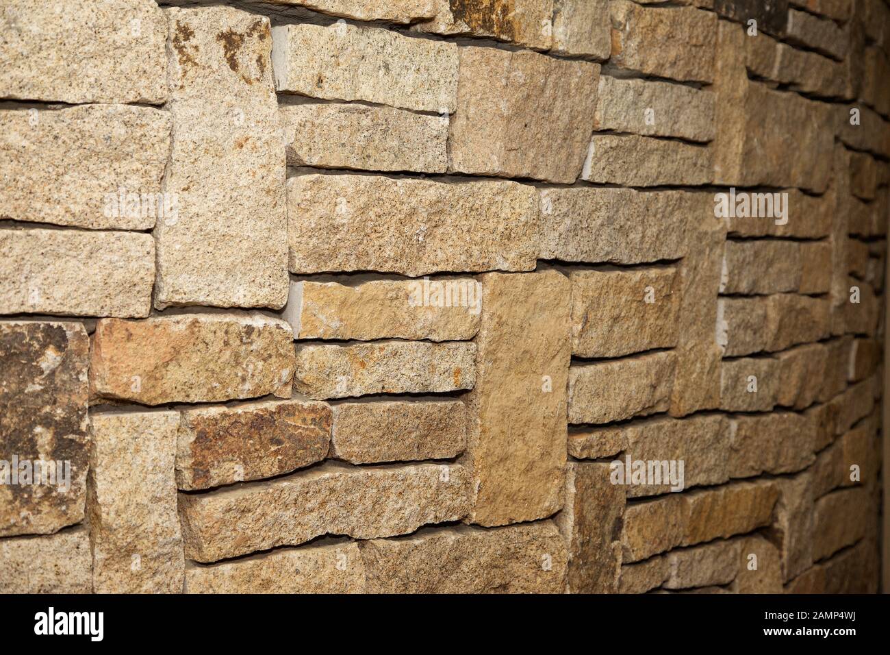 Close-up shot of a stone wall made of cut sandstone blocks. Stock Photo