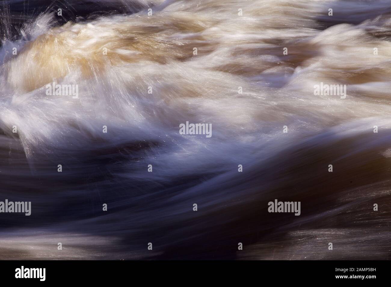 Abstract slow exposure shot of fast flowing white water. Stock Photo