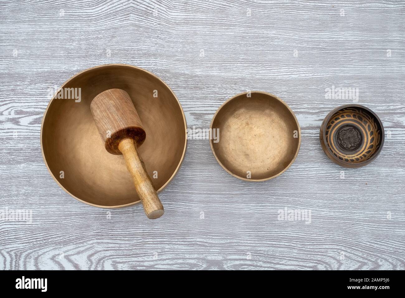 Flat lay composition of Ancient hand crafted traditional Tibetan meditation and healing singing bowls made from 7 sacred metals which are typical accessories used in buddhism, yoga and meditation Stock Photo