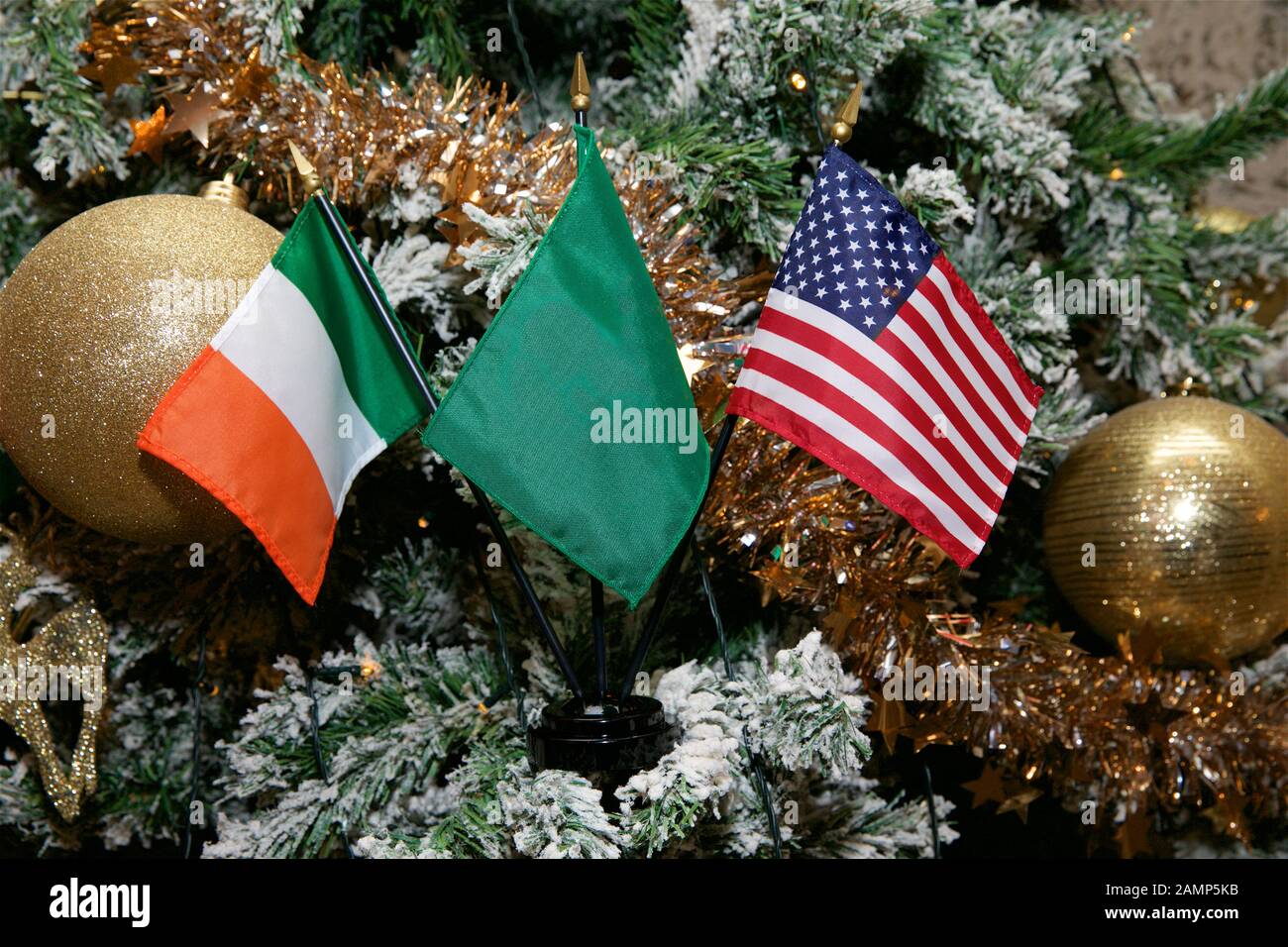 Irish American Christmas background: miniature Irish and American flags with Christmas decorations. Stock Photo