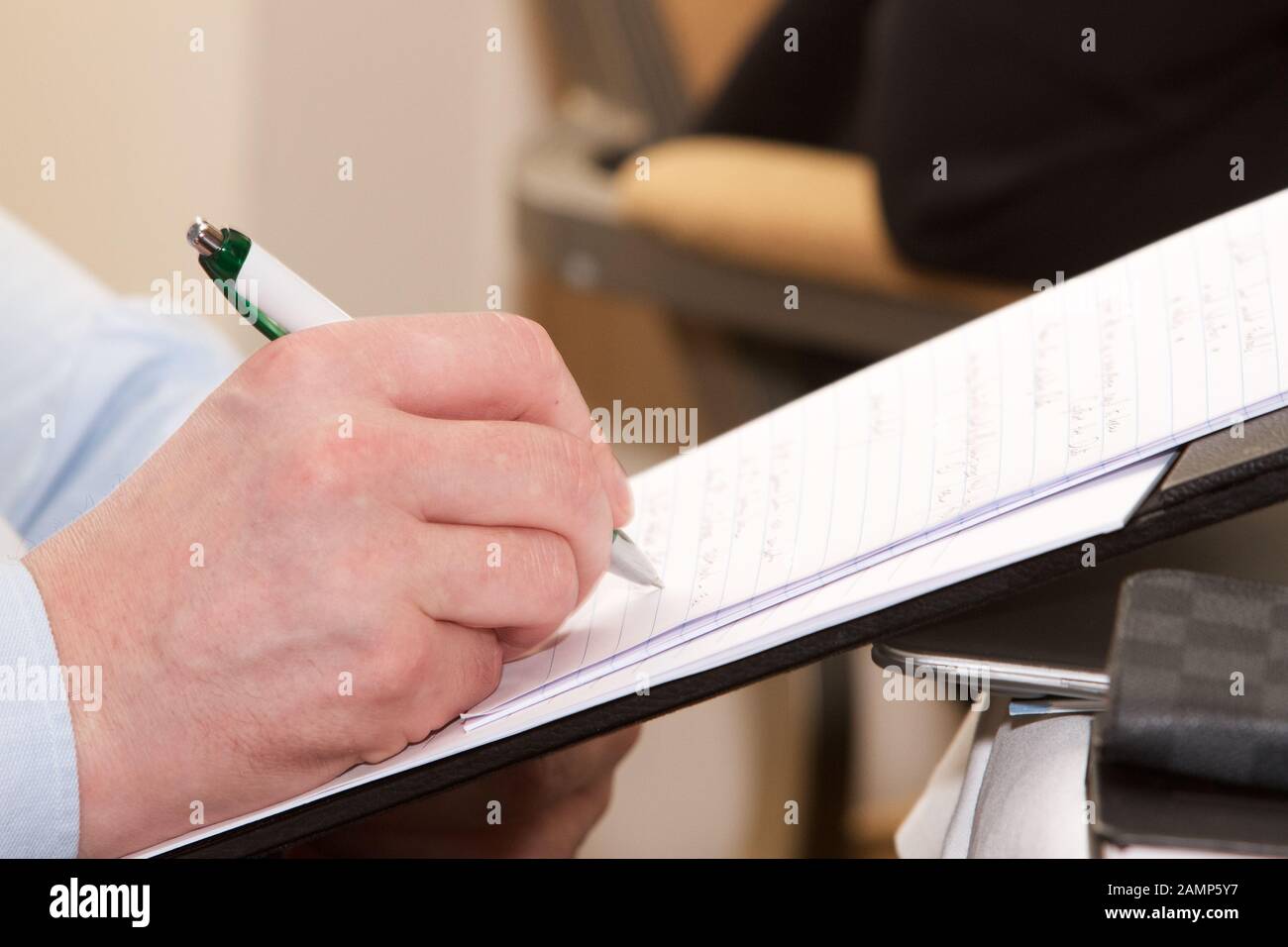 Taking notes at a business meeting or conference. Stock Photo