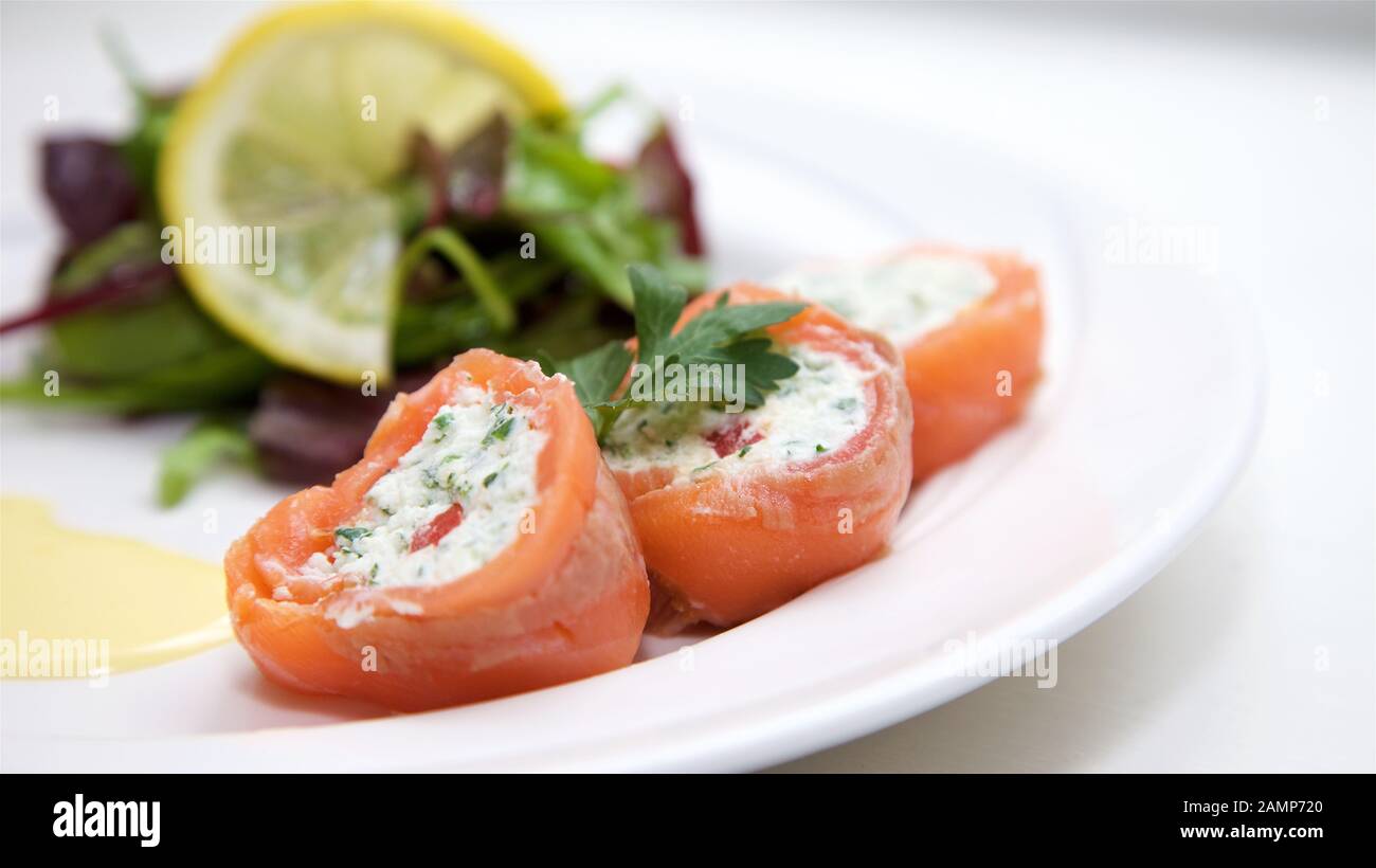 A restaurant starter dish of rolled smoke salmon and cream cheese. Stock Photo