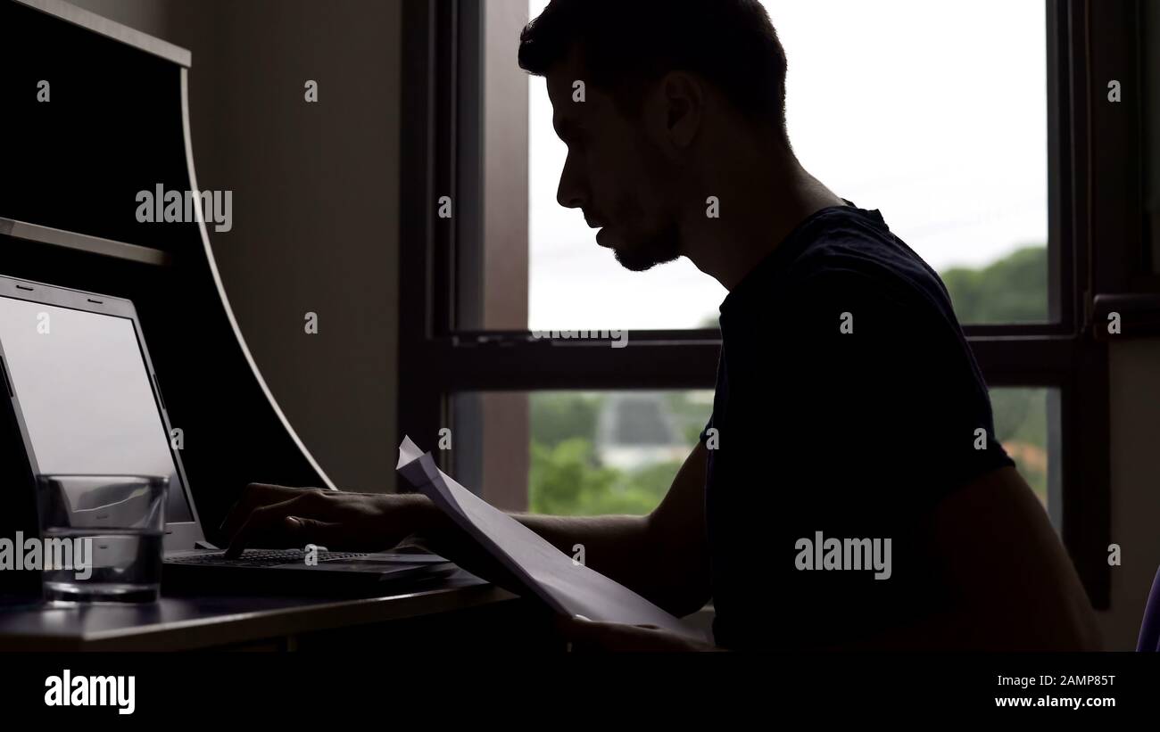 Marketer working all day, filling electronic database on laptop, freelancer Stock Photo
