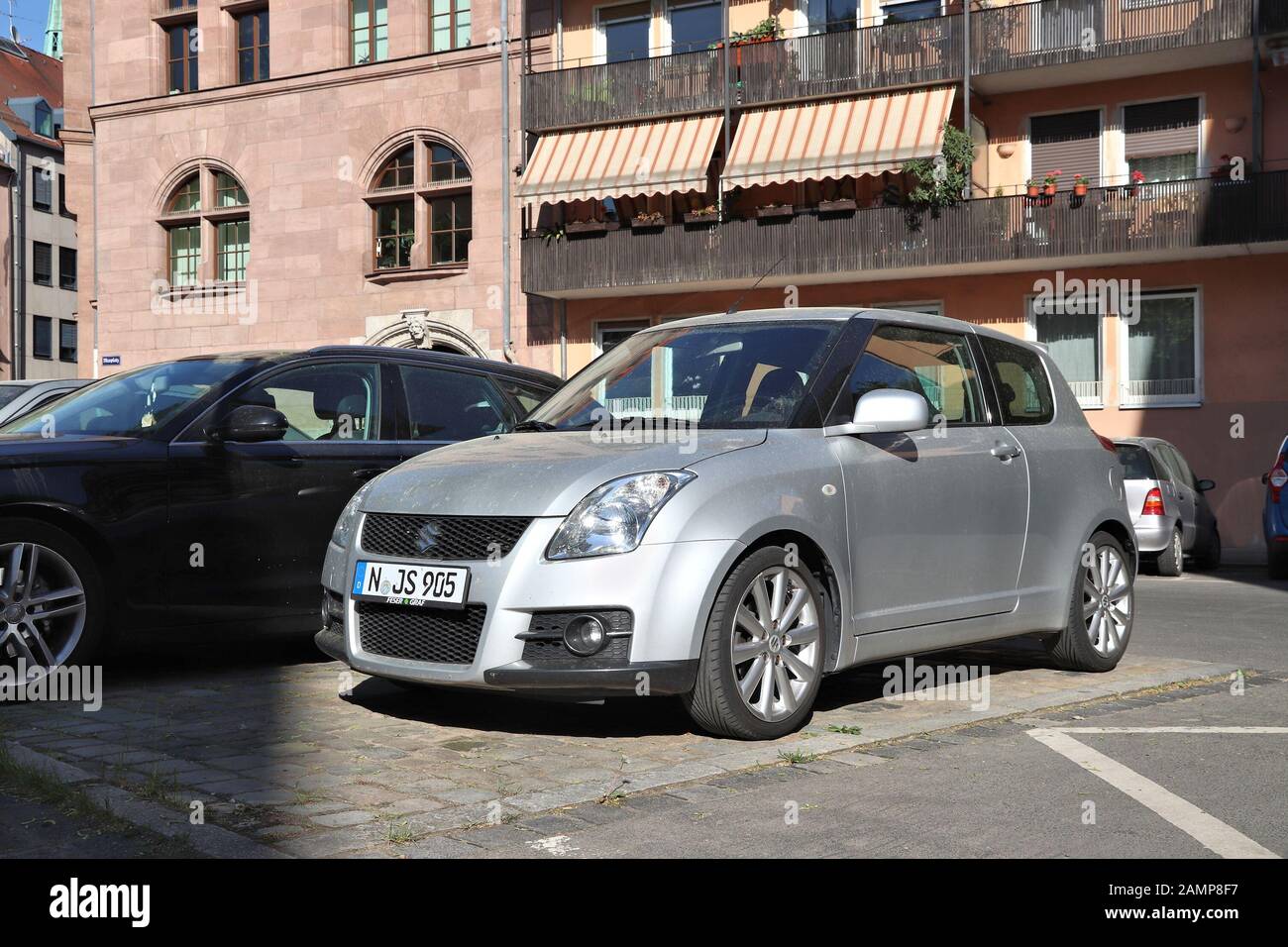 NUREMBERG, GERMANY - MAY 6, 2018: Silver Suzuki Swift compact hatchback car parked in Germany. There were 45.8 million cars registered in Germany (as Stock Photo