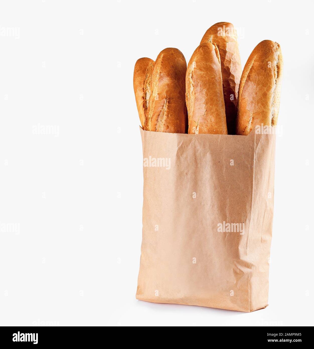 Baguette bread in paper bag on white background Stock Photo - Alamy