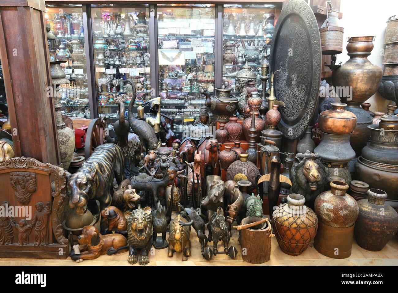 Dubai antique products at a market. Brass jars and wooden sculptures