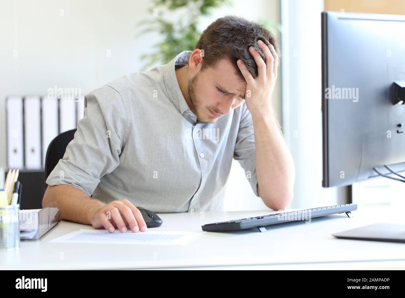 Sad entrepreneur complaining looking at negative chart at office Stock Photo
