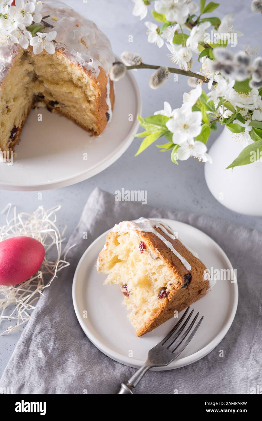 Easter orthodox cake and colorful red egg, spring flowers. Close up. Holidays traditional breakfast. Stock Photo