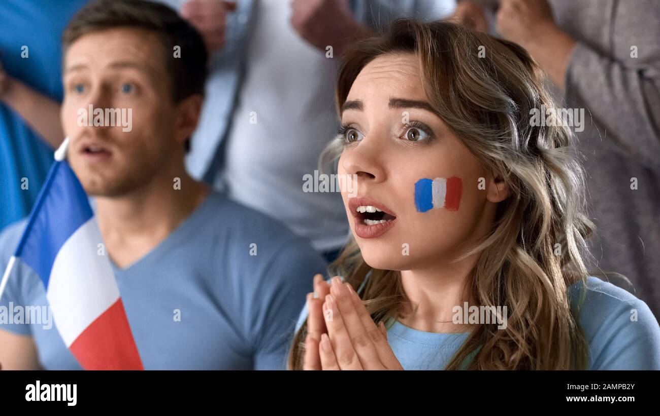 French football supporters watching final game together in pub, hope of victory Stock Photo